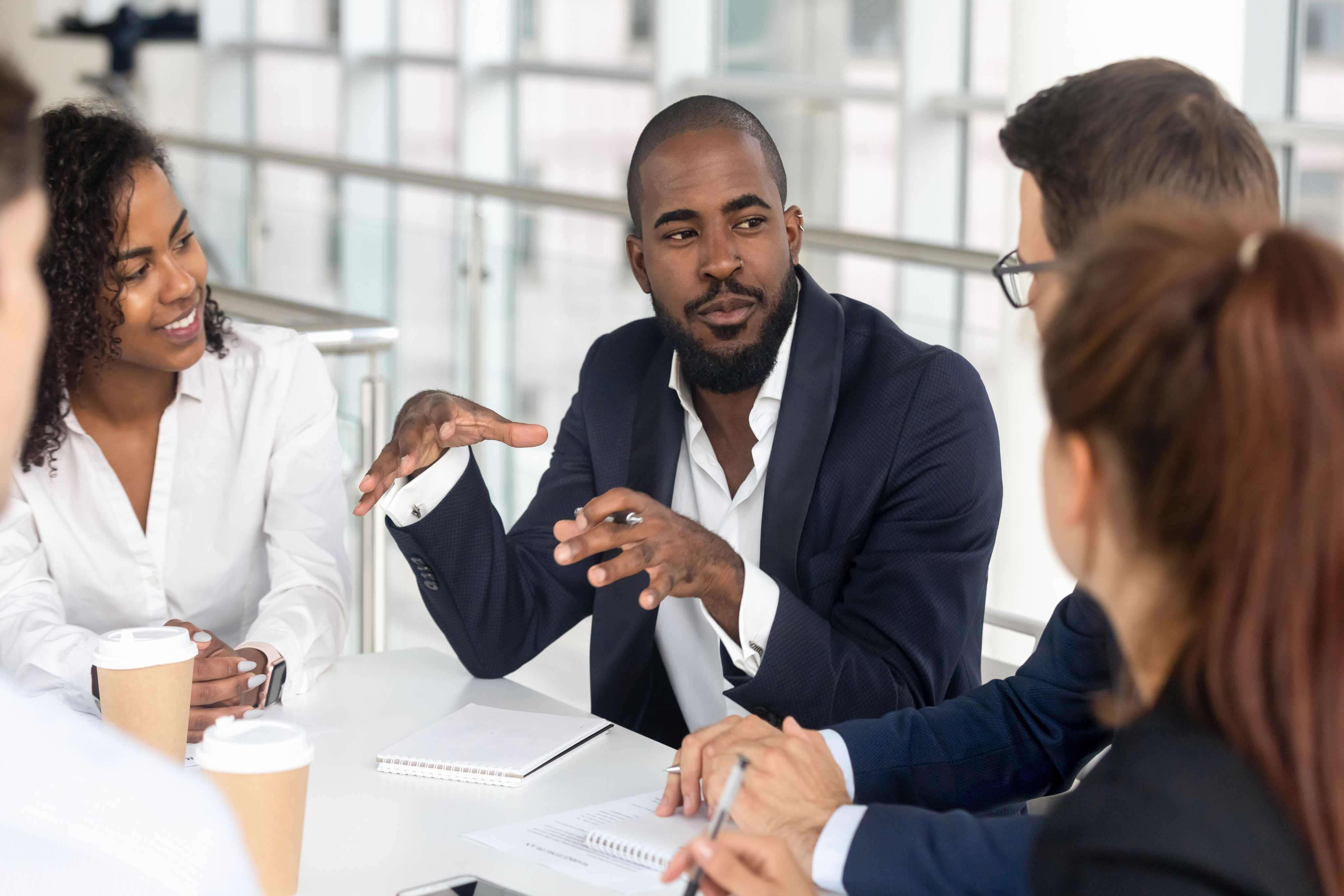 Business man talking to group in office